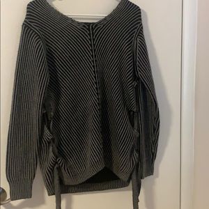 Knit sweater with draw strings on side